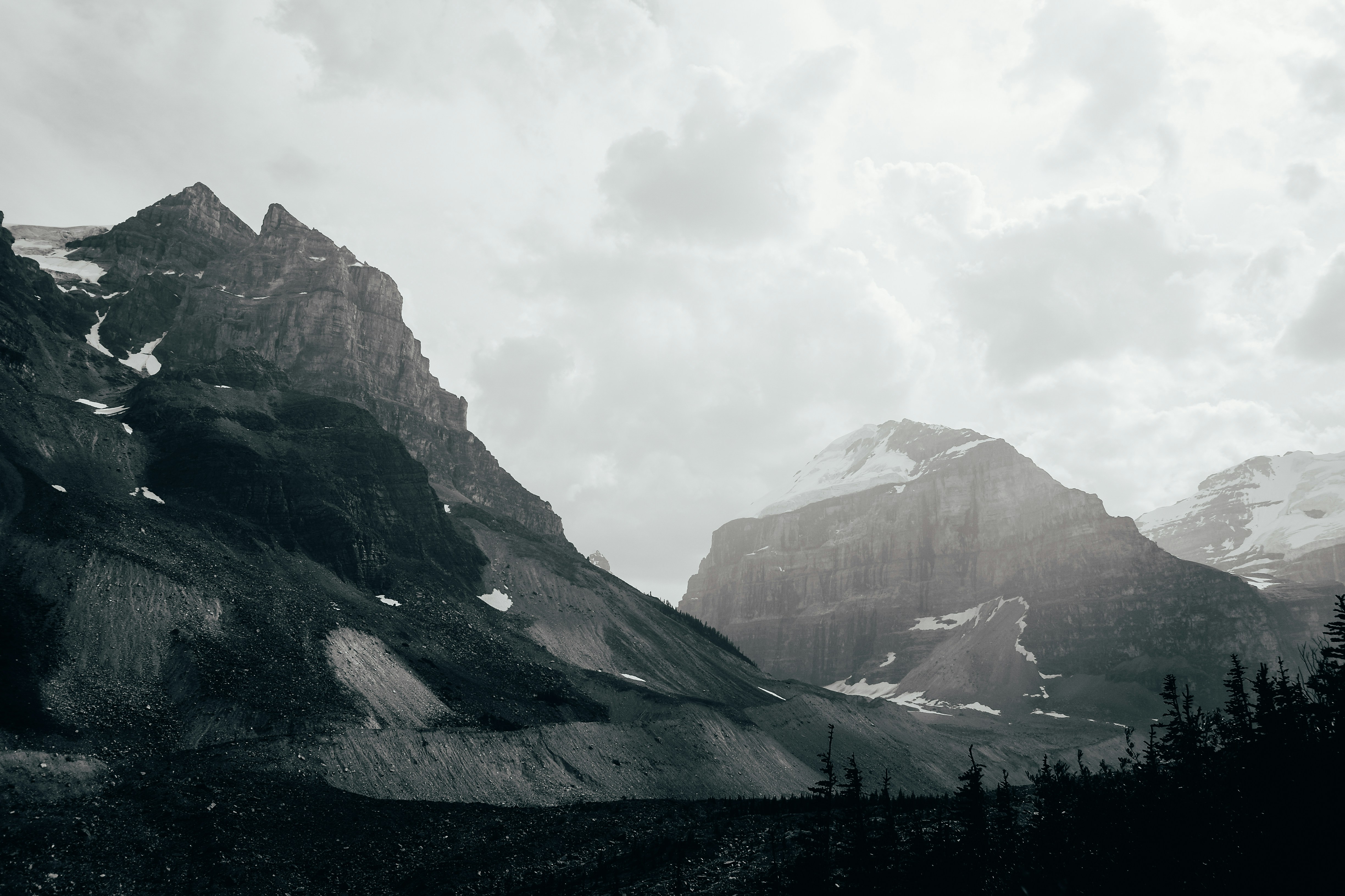 Snow Covered Mountains During Cloudy Day Photo Free Mountain Image On Unsplash