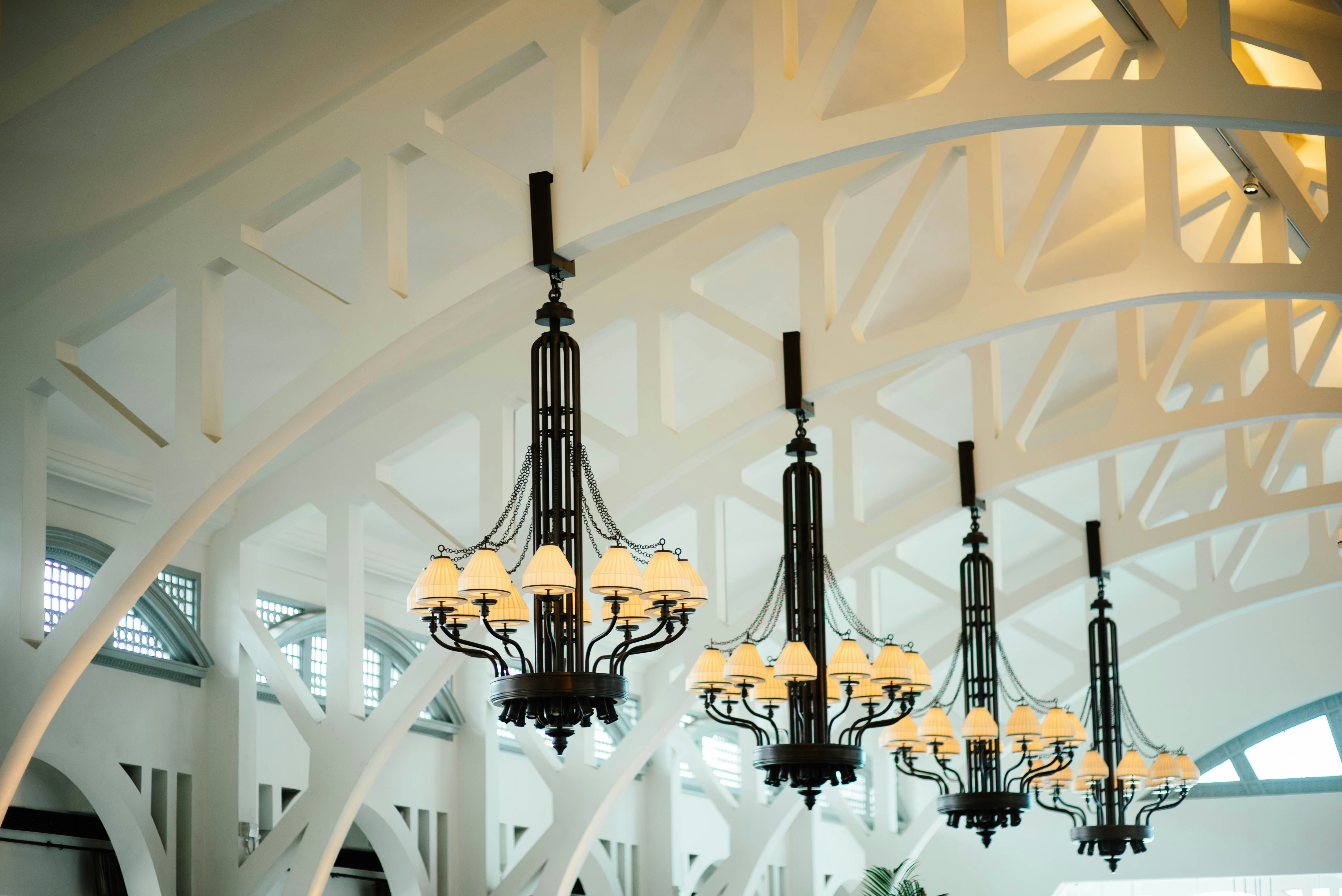 Four Black And White Chandeliers Inlined Hang In White Ceiling