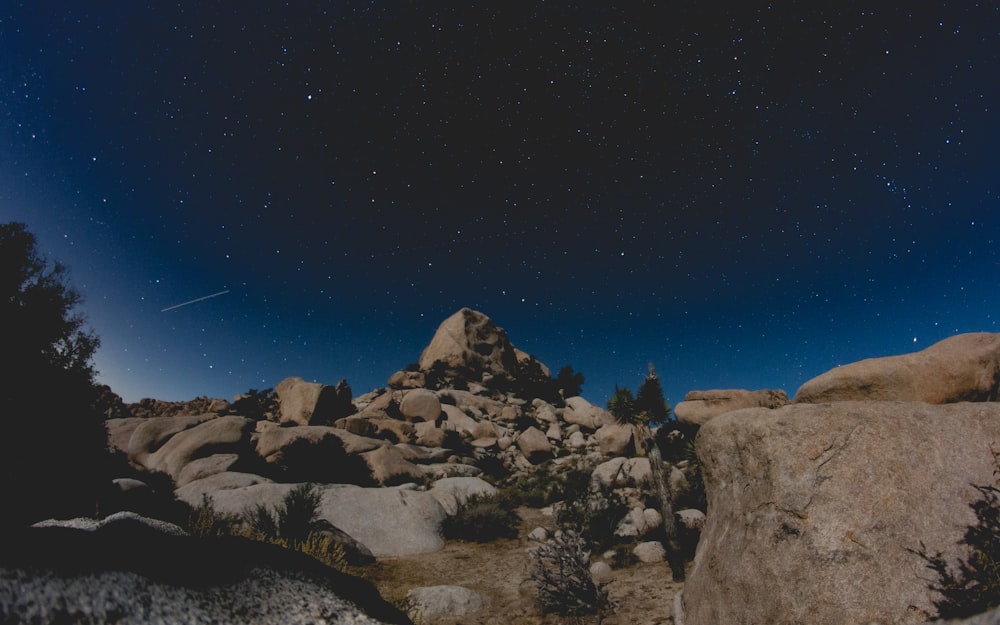 Formación rocosa marrón bajo el cielo nocturno azul