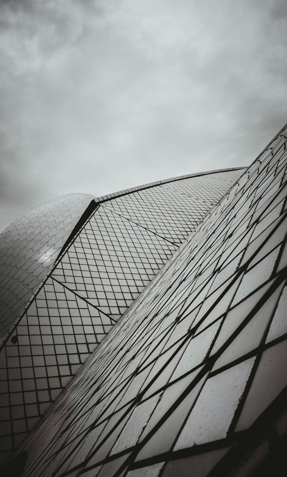 low angle photography of building under cloudy sky