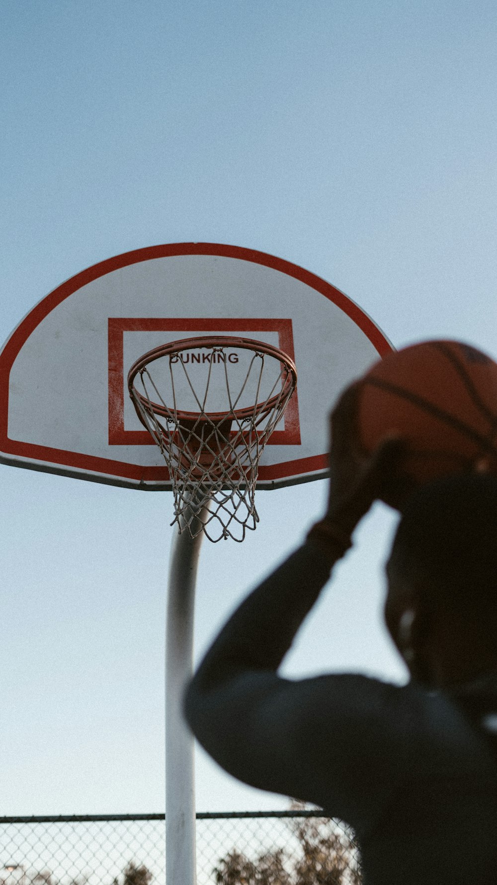 person trying to shoot the ball near basketball hoop