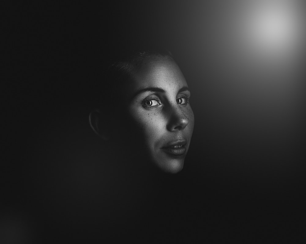 grayscale photo of woman's face