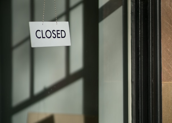 white closed hanging signage