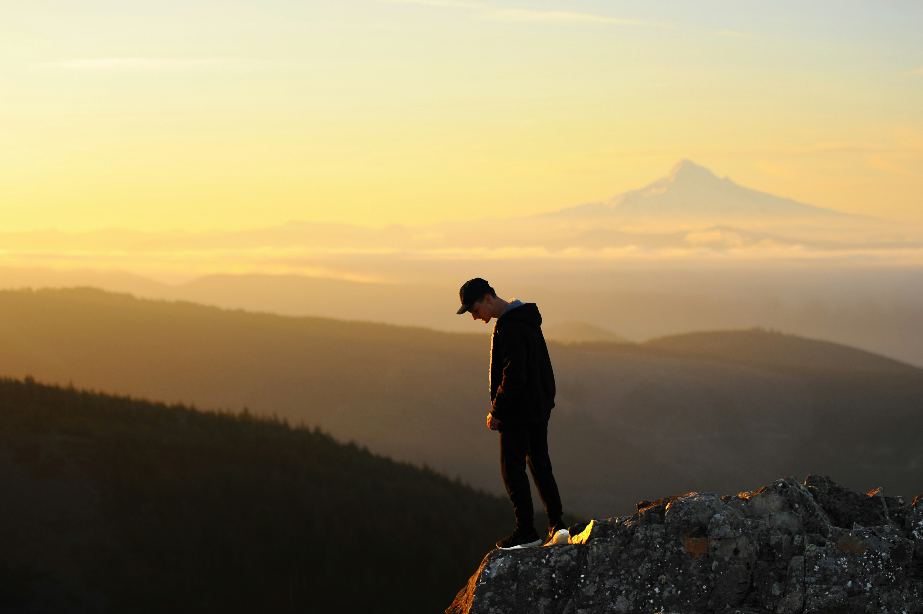 man standing on cliff, Look Down