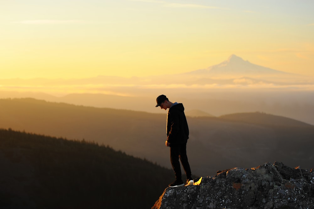 man standing on cliff