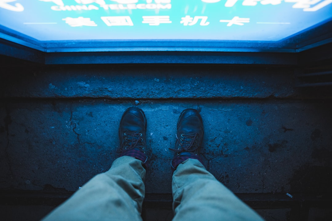 person step on gray concrete flooring