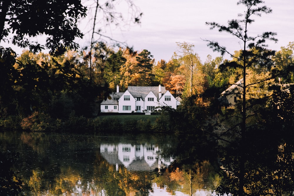 white concrete house near river