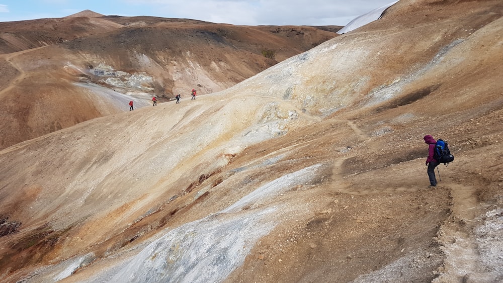 people walking on brown mountain during daytime