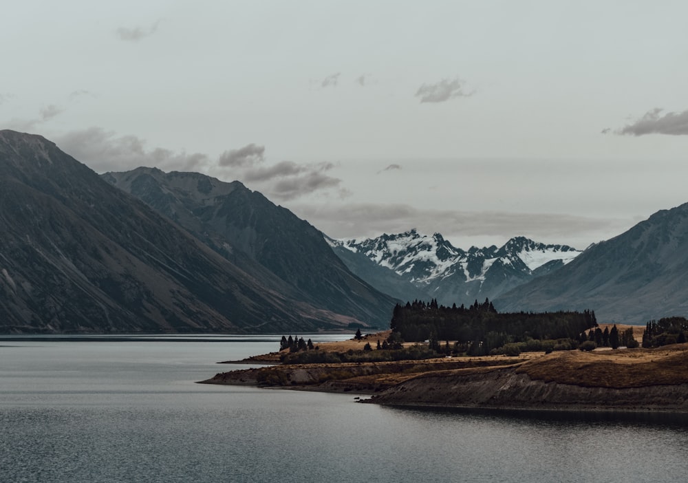 snowy mountain near body of water