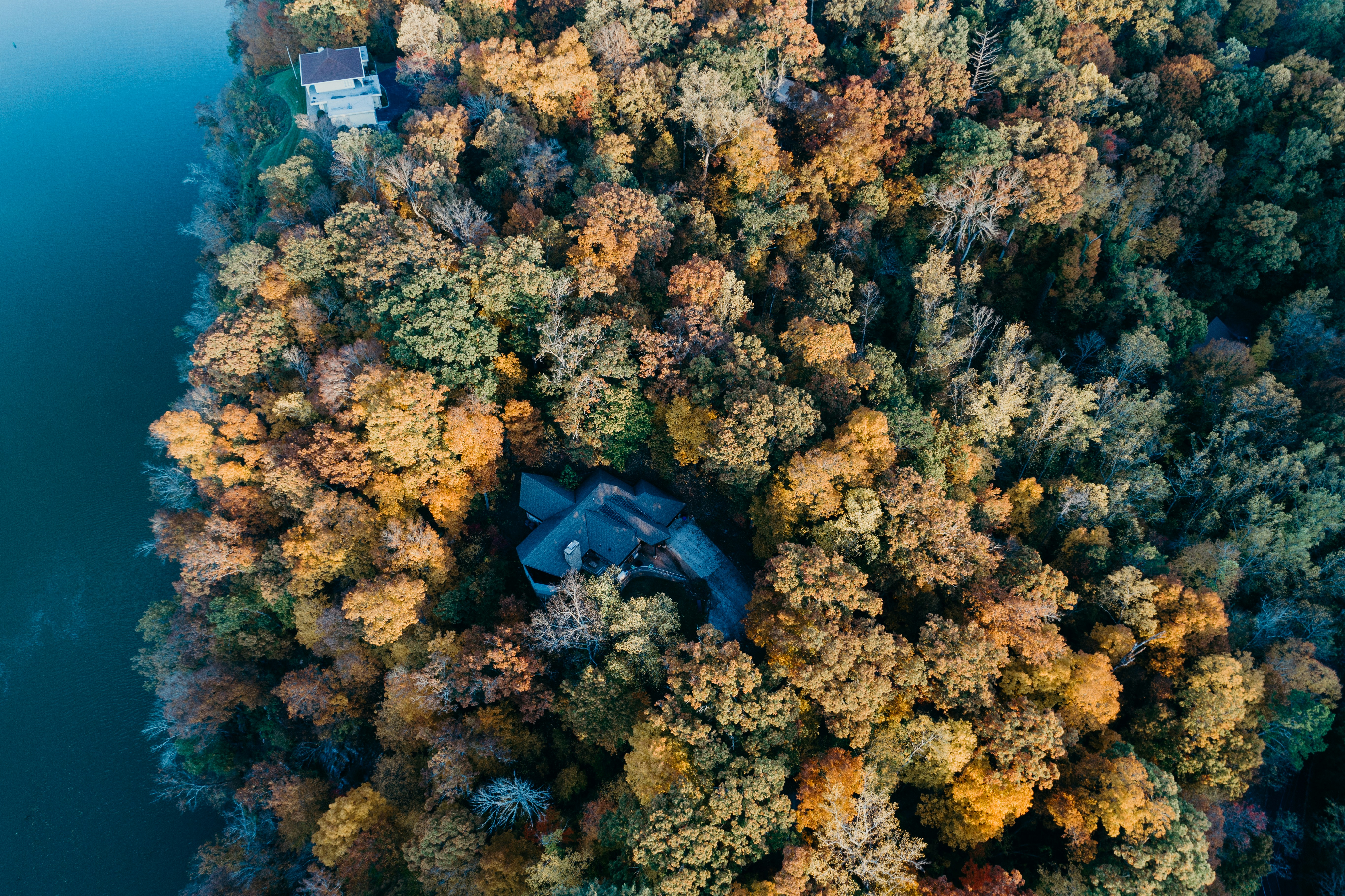 an aerial view of a house surrounded by trees