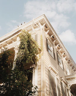 Close-up of charming wooden architectural details on the century-old ranch house with fresh green surroundings.