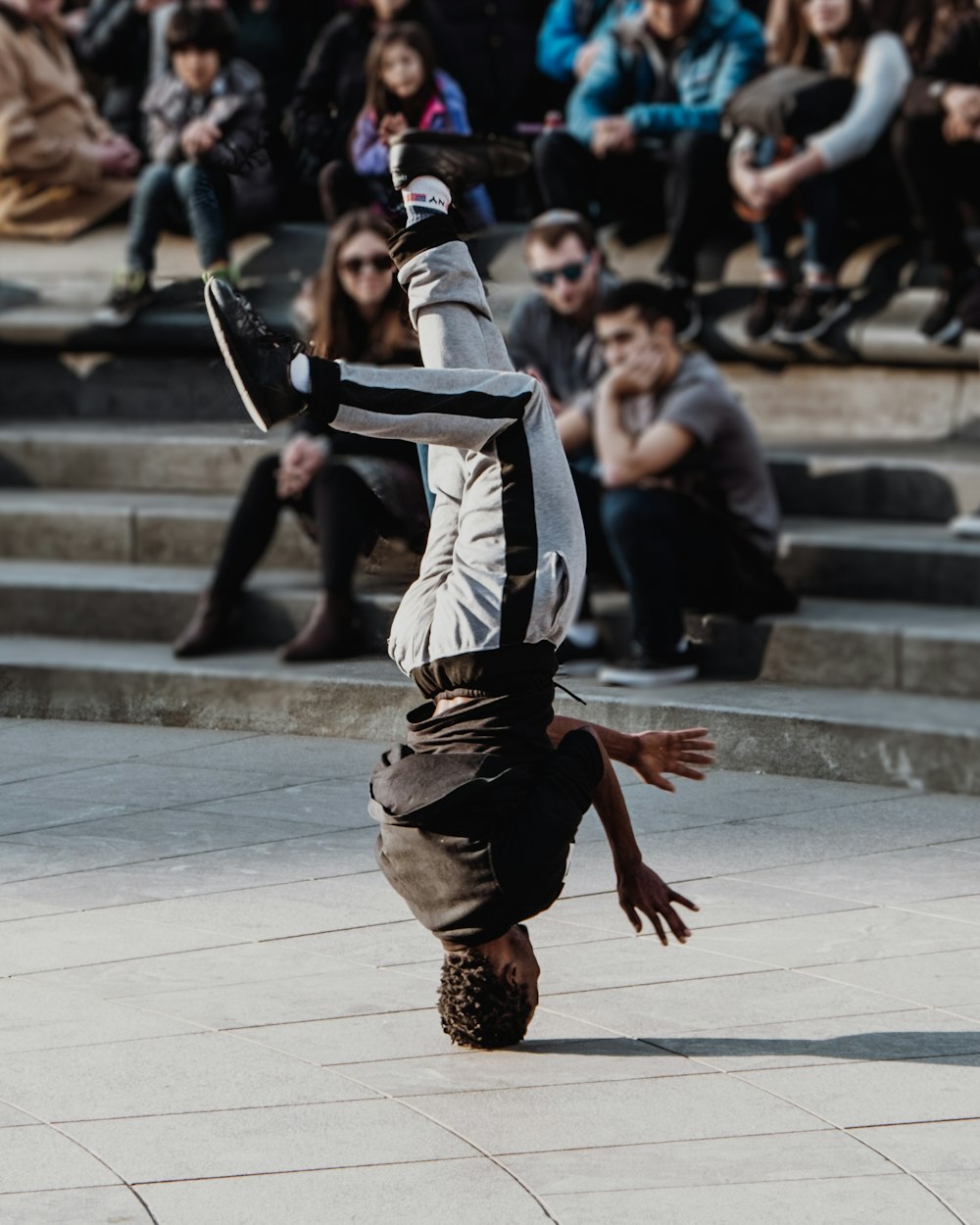 man doing head spin on park during daytime