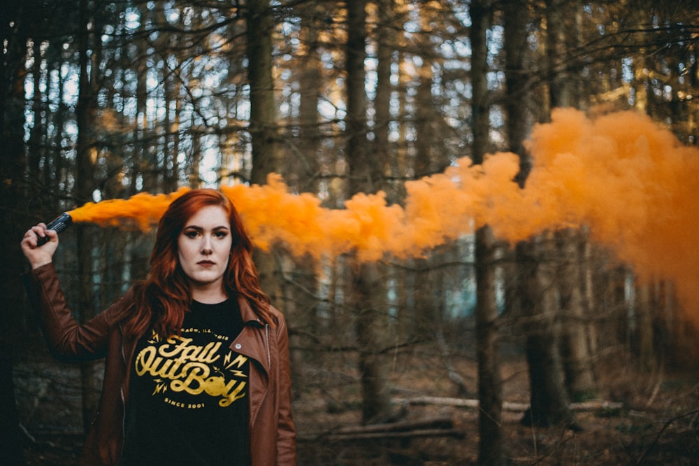 woman holding orange smoke flare