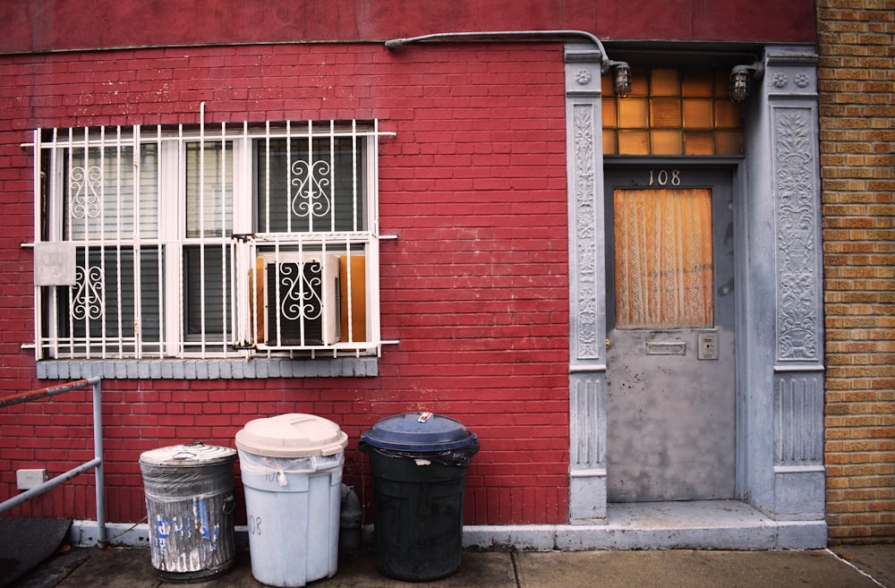 apartment number 108 with three trash bins