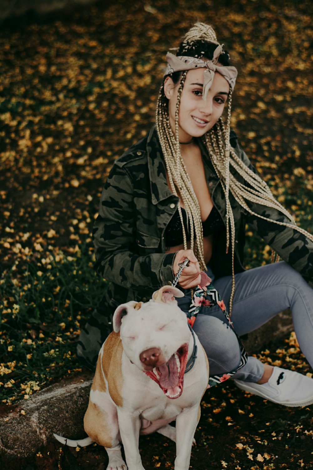 woman sitting beside short-coated dog