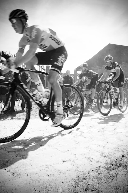 grayscale photography of people ridding bicycles in Roubaix France