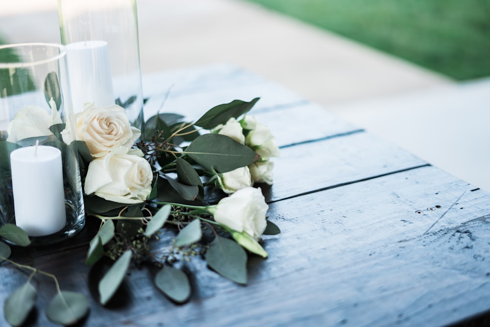 white and yellow roses beside white pillar