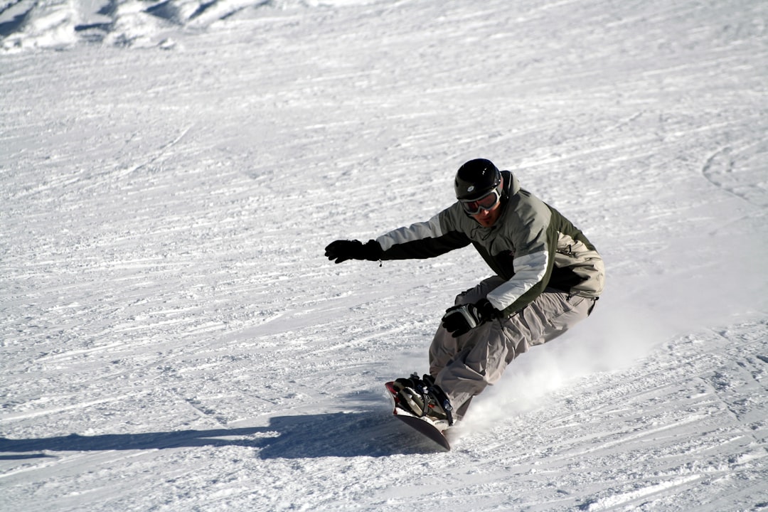 man snowboarding gliding on snow