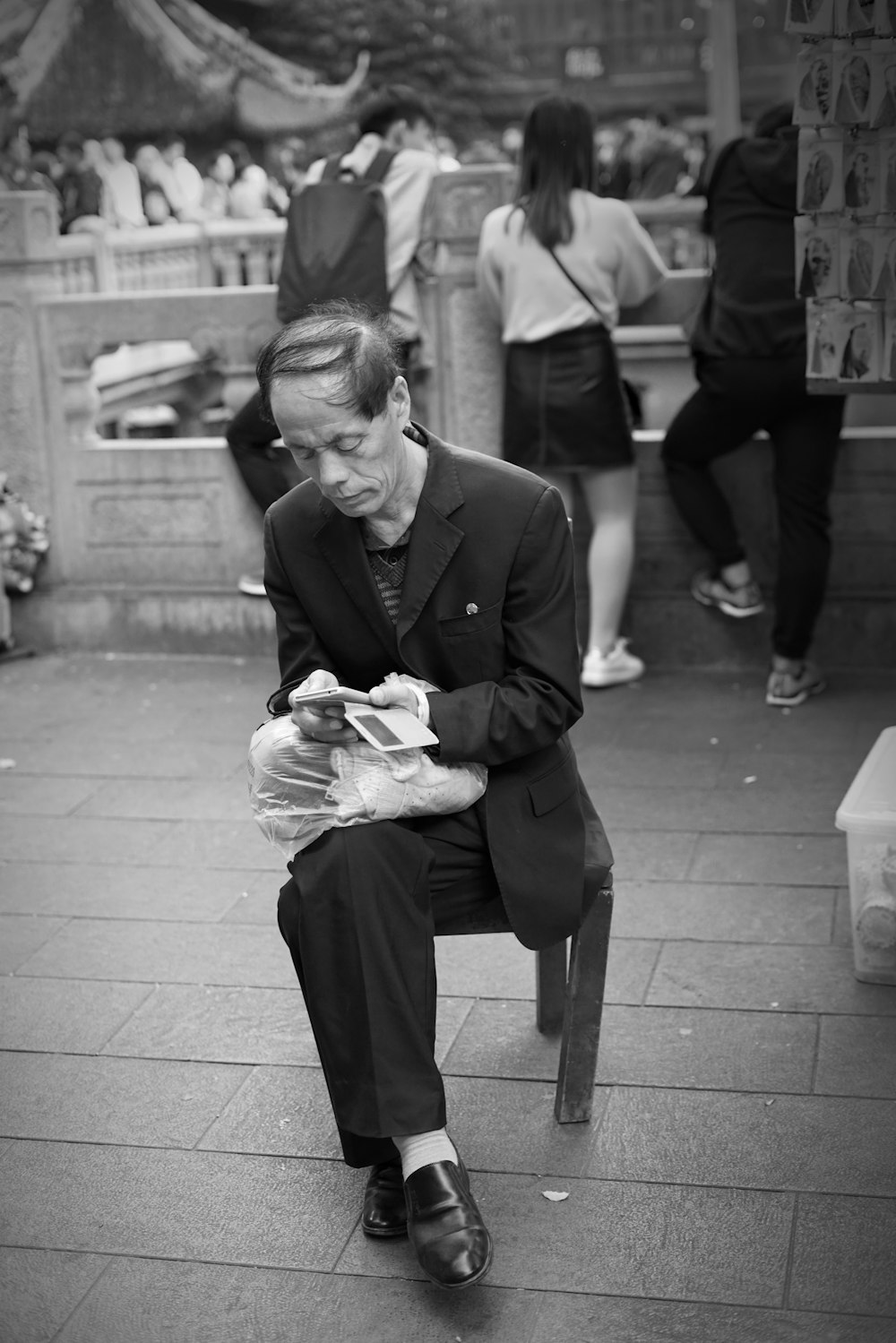 grayscale man sitting on chair