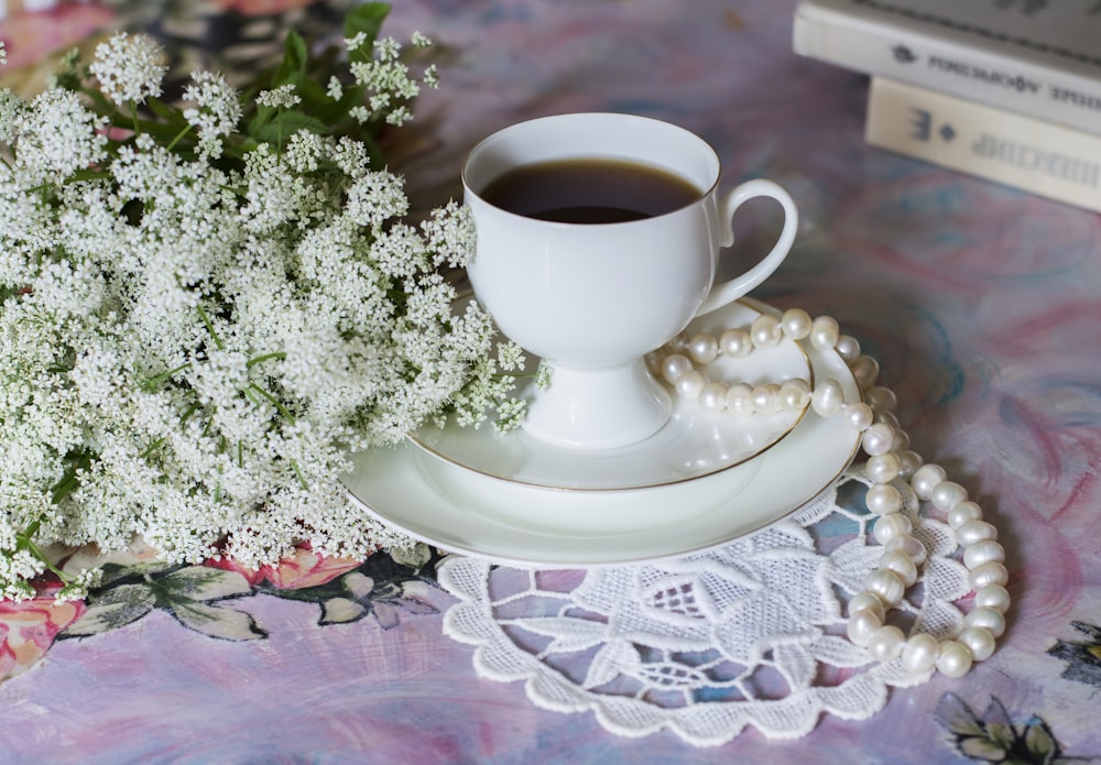 white ceramic cup on ceramic saucer