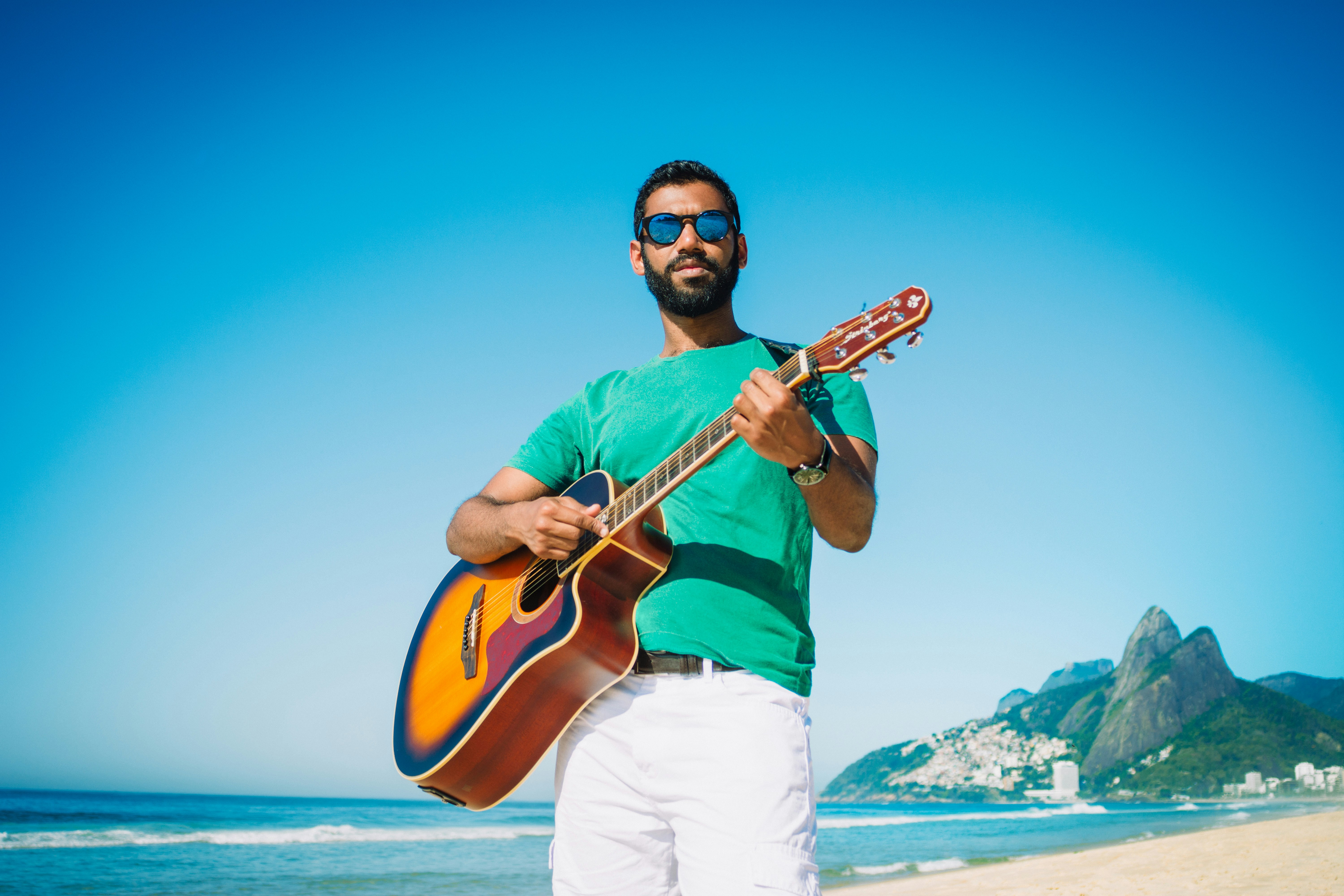 Nikon D7100 + Sigma 24mm F2.8 Super Wide II Macro sample photo. Man playing guitar near photography