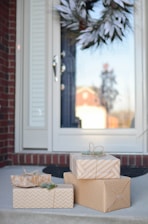 four brown gift boxes near white door