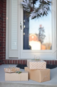 four brown gift boxes near white door
