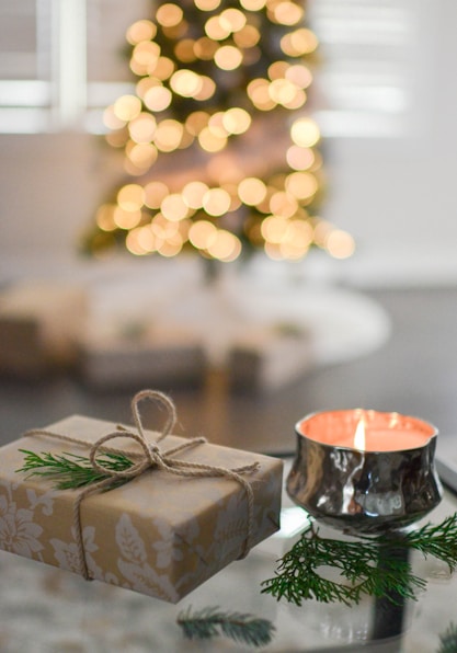 brown gift box beside stainless steel votive candle