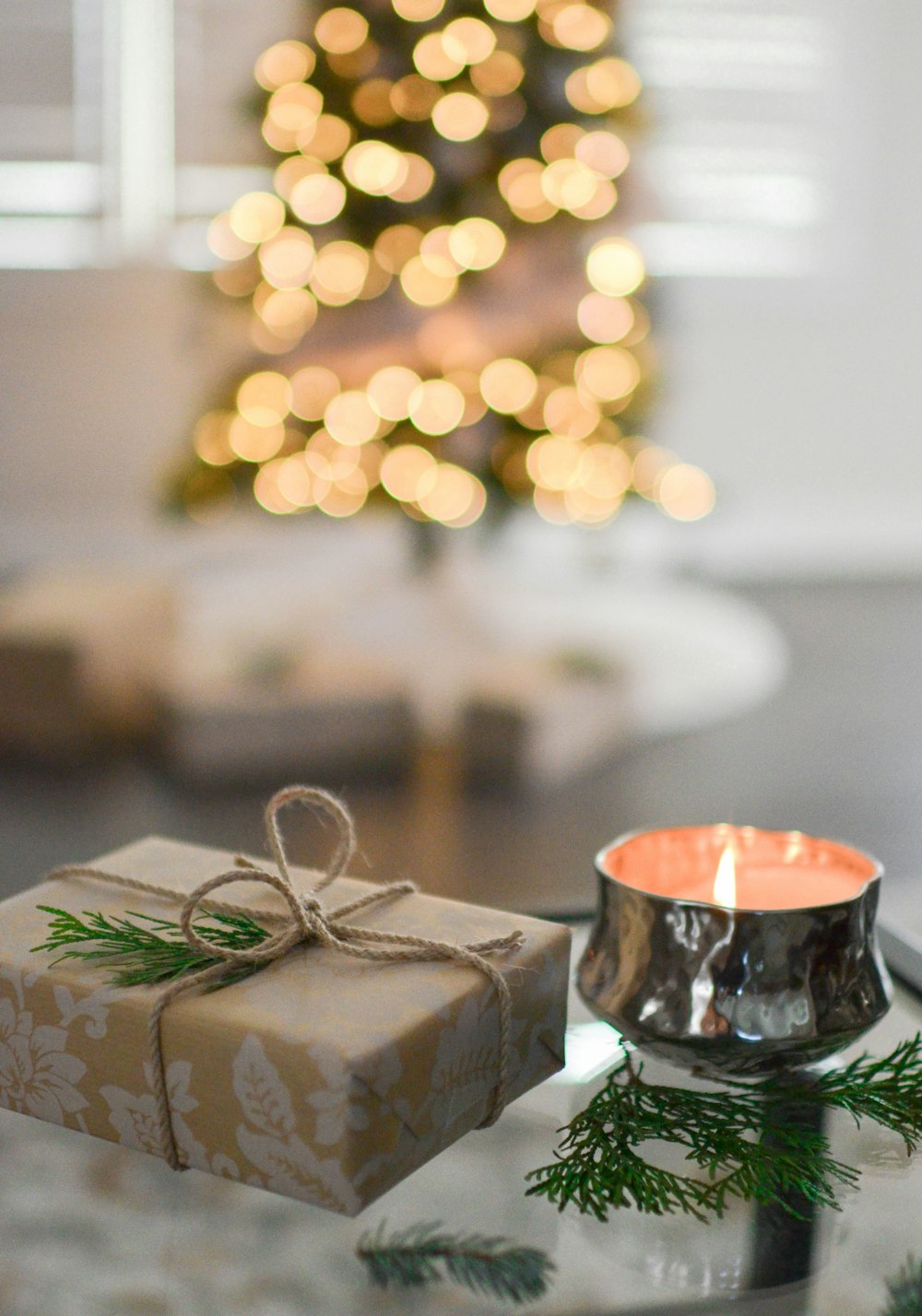 brown gift box beside stainless steel votive candle