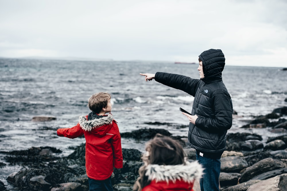 man and boy in seashore at daytime