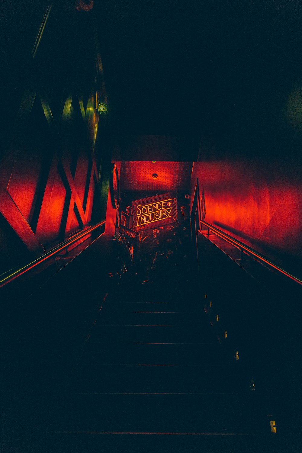 an escalator in a building with a red light