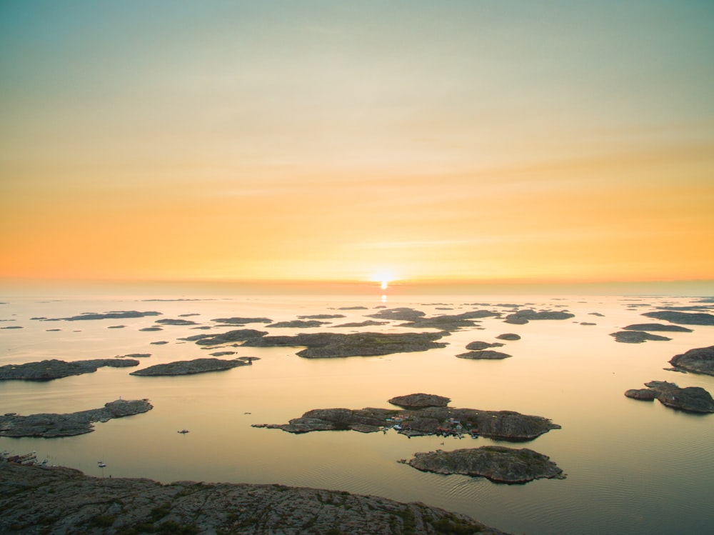 aerial photography of body of water with rocks