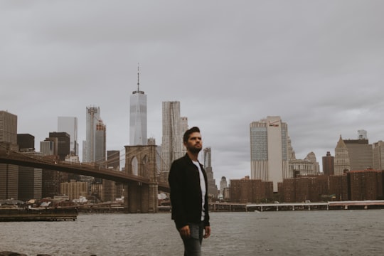 man standing near sea with building background in Main Street Park United States