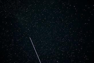 A night sky filled with stars and a digital network overlay representing AI connections.