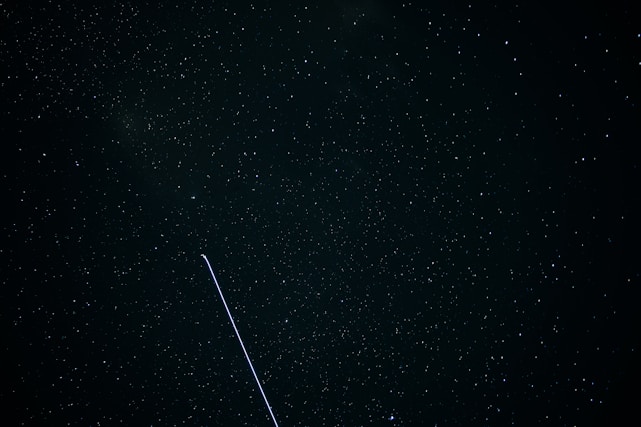 A vibrant night sky filled with satellites orbiting Earth against a backdrop of stars