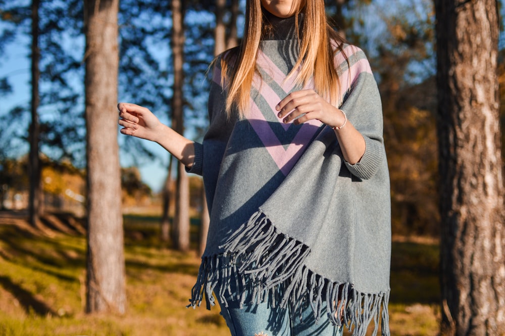 woman standing surrounded by tress