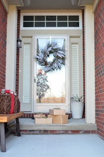 wreath hanging on full-lite door of house