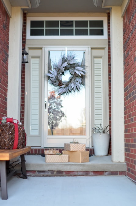 wreath hanging on full-lite door of house