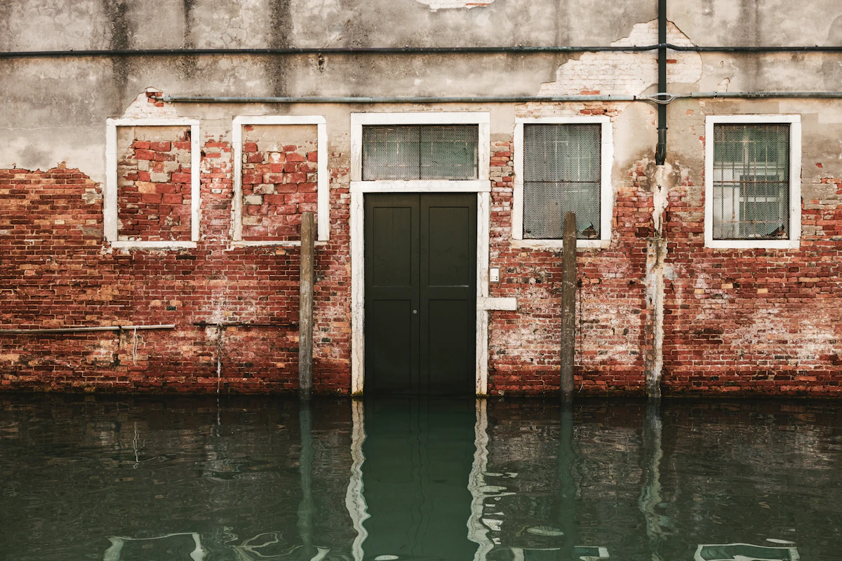 Floodwater at a building entrance — the kind of emergency a 24/7 answering service for water damage restoration has to triage