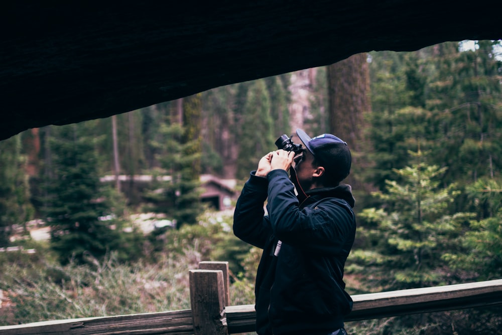 man taking picture using camera