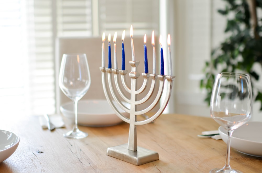 brass-colored candle holder on brown table