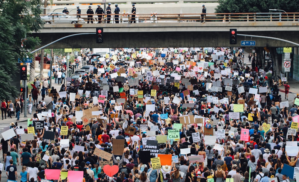 a large group of people holding up signs