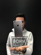 Social media icons floating above a smartphone held by a person