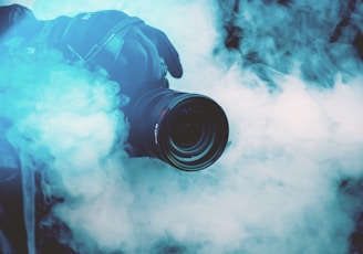 person holding DSLR camera with fogs