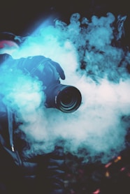 person holding DSLR camera with fogs