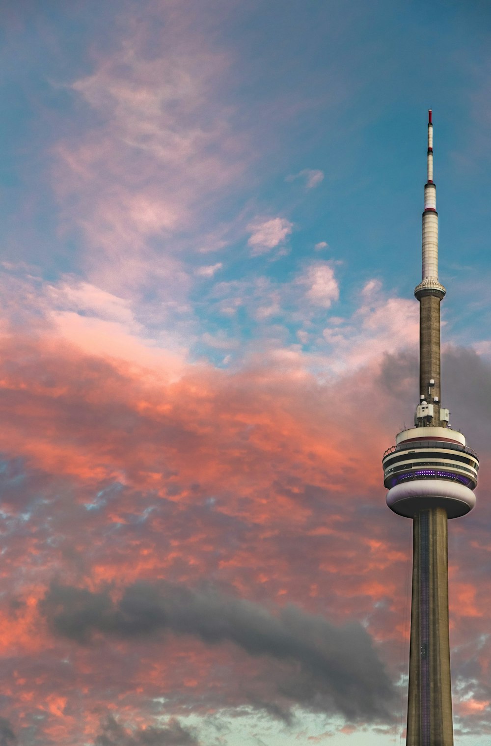CN Tower under red and gray clouds