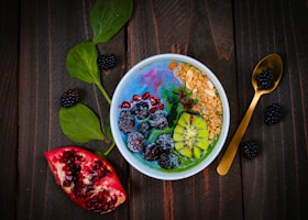 mixed fruits on bowl with blueberry on top