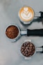 flat lay photography of coffee latte, ground coffee, and coffee beans