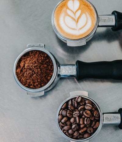 flat lay photography of coffee latte, ground coffee, and coffee beans