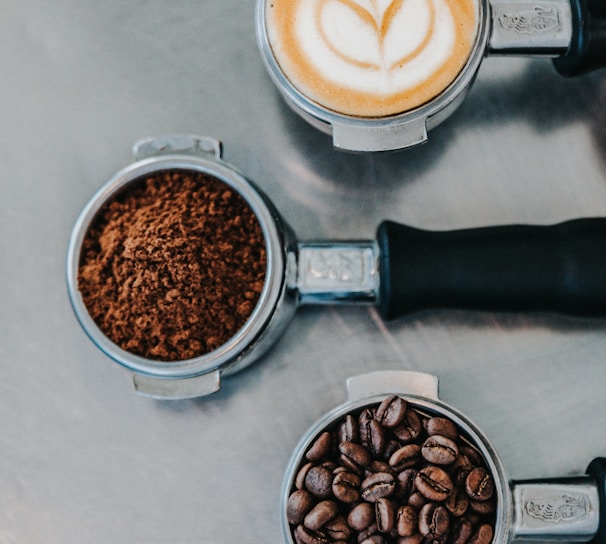 flat lay photography of coffee latte, ground coffee, and coffee beans